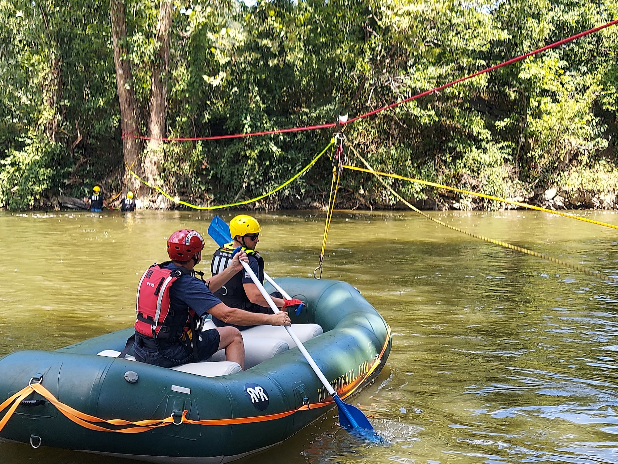 U.S. Air Force Staff Sgt. Ryan Runk, a fire fighter for the 167th Civil Engineering Squadron, in the front of the boat, receives swift water rescue training from an instructor with the Berkeley County Office of Emergency Management, in Jefferson County, West Virginia, July 21, 2022.