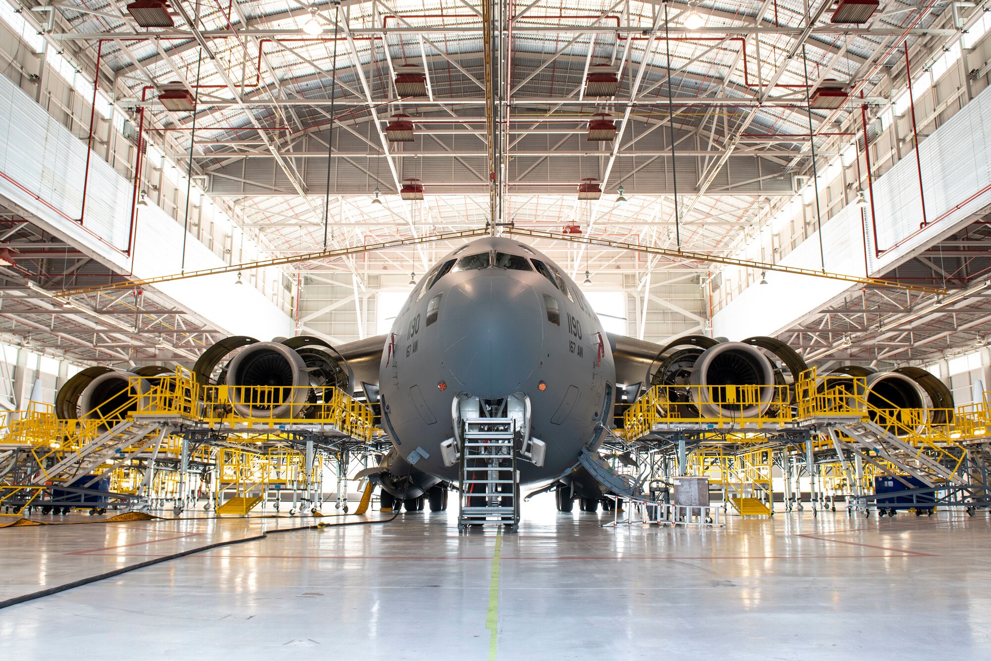 A C-17 Globemaster III aircraft’s wings are flanked by newly manufactured maintenance stands while it’s parked in the home station check aircraft hangar at the 167th Airlift Wing, Shepherd Field, Martinsburg, West Virginia, July 21, 2022.
