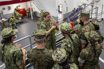 220727-N-ZW825-0143 GREAT LAKES, Ill. (July 27, 2022) Naval Reserve Officers Training Corps (NROTC) New Student Indoctrination (NSI) Cycle 3 midshipman candidates observe the proper execution of tying a bowline knot aboard the USS Marlinespike seamanship trainer at Recruit Training Command (RTC), July 27. Upon completion of NSI, the candidates will start their freshman year of the NROTC program at colleges and universities nationwide this fall. NSI is an indoctrination program hosted at RTC, and provides midshipmen with a common military training orientation. NSI provides basic training in five warfighting fundamentals – firefighting, damage control, seamanship, watchstanding and small arms handling and marksmanship – to begin creating basically trained and smartly disciplined future Navy and Marine Corps officers. NROTC is overseen by Commander, Naval Service Training Command (NSTC), Rear Adm. Jennifer S. Couture, which supports naval accessions training for 98 percent of the Navy’s new officers and enlisted Sailors. (U.S. Navy photo by Chief Mass Communication Specialist Byron C. Linder)