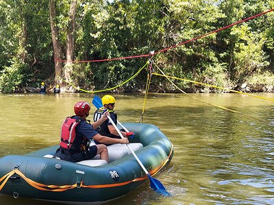 U.S. Air Force Staff Sgt. Ryan Runk, a firefighter for the 167th Civil Engineering Squadron, in the front of the boat, receives swift water rescue training from an instructor with the Berkeley County Office of Emergency Management in Jefferson County, West Virginia July 21, 2022.