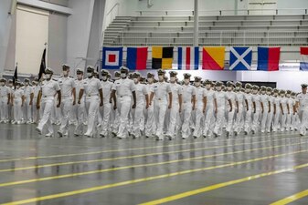 GREAT LAKES, Ill. (Aug. 8, 2022) Naval Reserve Officers Training Corps (NROTC) New Student Indoctrination (NSI) 2022 Cycle 3 midshipman candidates graduate from NSI in the Midway Ceremonial Drill Hall at Recruit Training Command (RTC), August 8. The midshipmen will start their freshman year of the NROTC program at colleges and universities nationwide this fall. NSI is an indoctrination program hosted at RTC, and provides midshipmen with a common military training orientation. NSI provides basic training in five warfighting fundamentals – firefighting, damage control, seamanship, watchstanding and small arms handling and marksmanship – to begin creating basically trained and smartly disciplined future Navy and Marine Corps officers. NROTC is overseen by Commander, Naval Service Training Command (NSTC), Rear Adm. Jennifer S. Couture, which supports naval accessions training for 98 percent of the Navy’s new officers and enlisted Sailors. (U.S. Navy photo by Mass Communication Specialist 2nd Class Nikita Custer)
