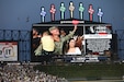 U.S. Army Reserve Staff Sgt. Andrew Raynor, with his son, Jacob, and wife Stacy, are cheered on a jumbotron during a ‘Hero of the Game’ honor at a Chicago White Sox versus Kansas City Royals game in Chicago, August 2, 2022.