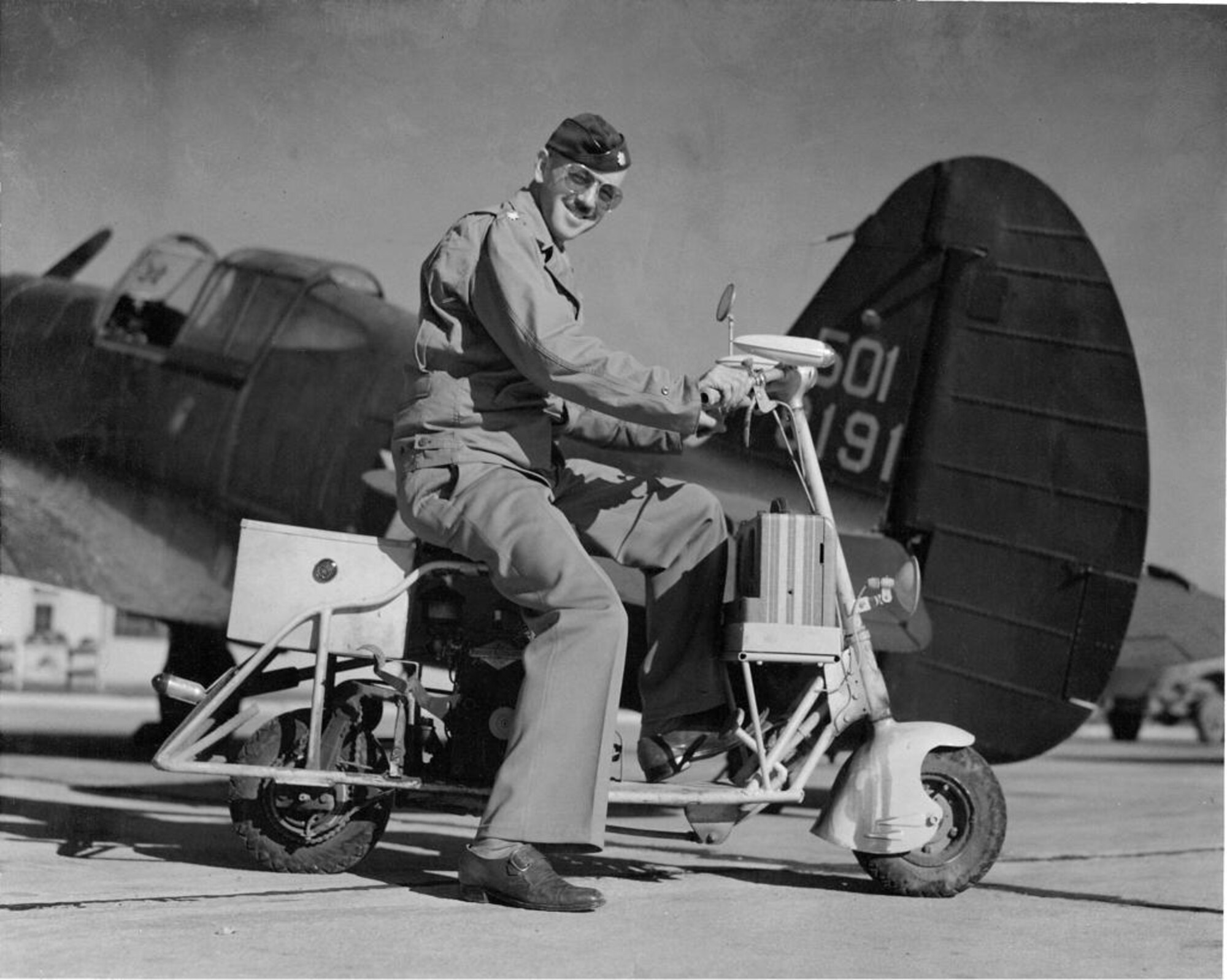 U.S. Air Force 1st Lt. Chad Chapman's great-grandfather, retired Lt. Col. William "Bill" Chapman poses on a motorbike in front of a p-36 Hawk. (U.S. Air Force courtesy photo)