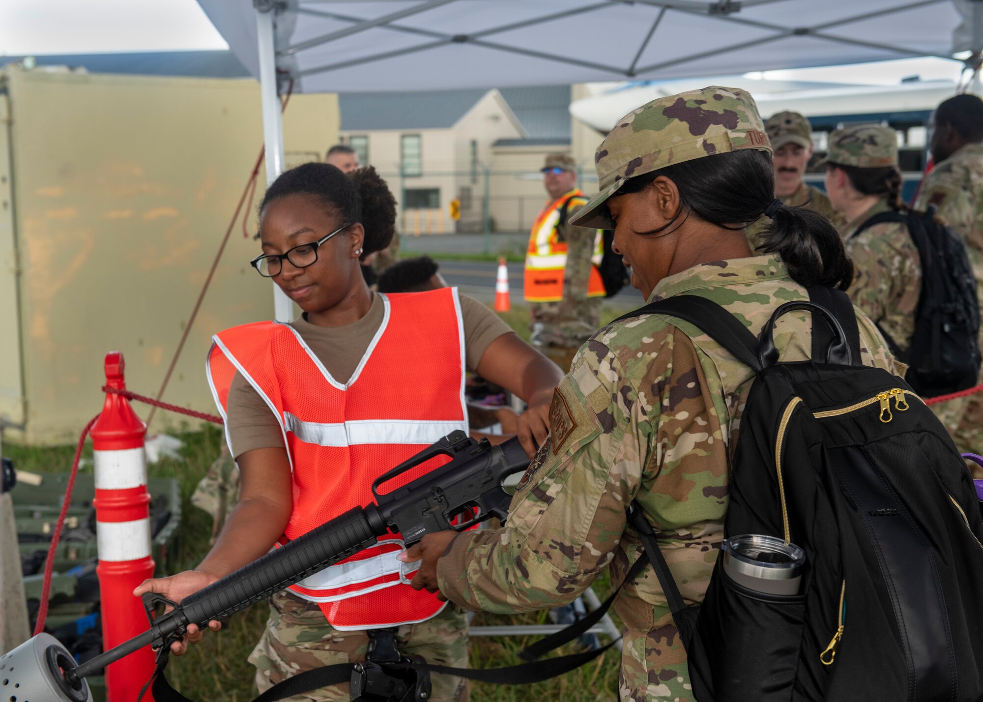Members from the 512th and 436th airlift wings clear M16 rifles at the end of their shift during the Liberty Eagle Readiness Exercise at Dover Air Force Base, Delaware, July 13, 2022. Members from both wings participated in a simulated deployment to a forward operating base, located on Dover AFB, July 11-15, 2022. The purpose of this exercise was to validate the 512th and 436th airlift wings' ability to generate, employ and sustain airpower across the world in a contested and degraded operational environment. (U.S. Air Force photo by Senior Airman Shayna Hodge)