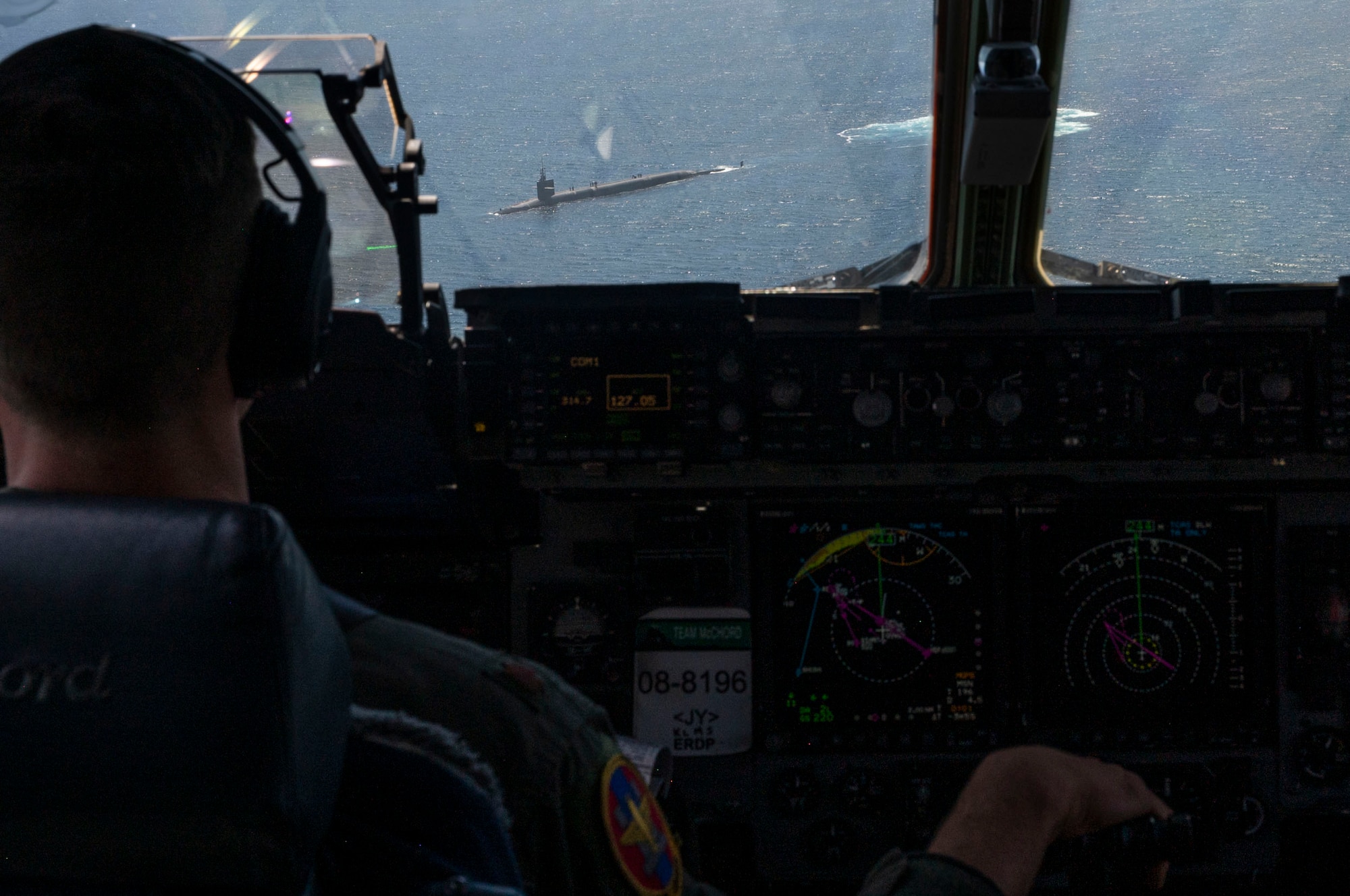 U.S. Air Force Maj. Thomas Browning, a pilot with the 62d Operations Squadron, flies a C-17 Globemaster III during a vertical replenishment to USS Henry M. Jackson (SSBN 730) over the Pacific Ocean, July 19, 2022. Experts at Air Mobility Command’s 2022 Mobility Air Forces Weapons and Tactics Conference explored innovative solutions to problems faced by the joint force, including maritime resupply operations to maintain persistent and enduring strategic deterrence.