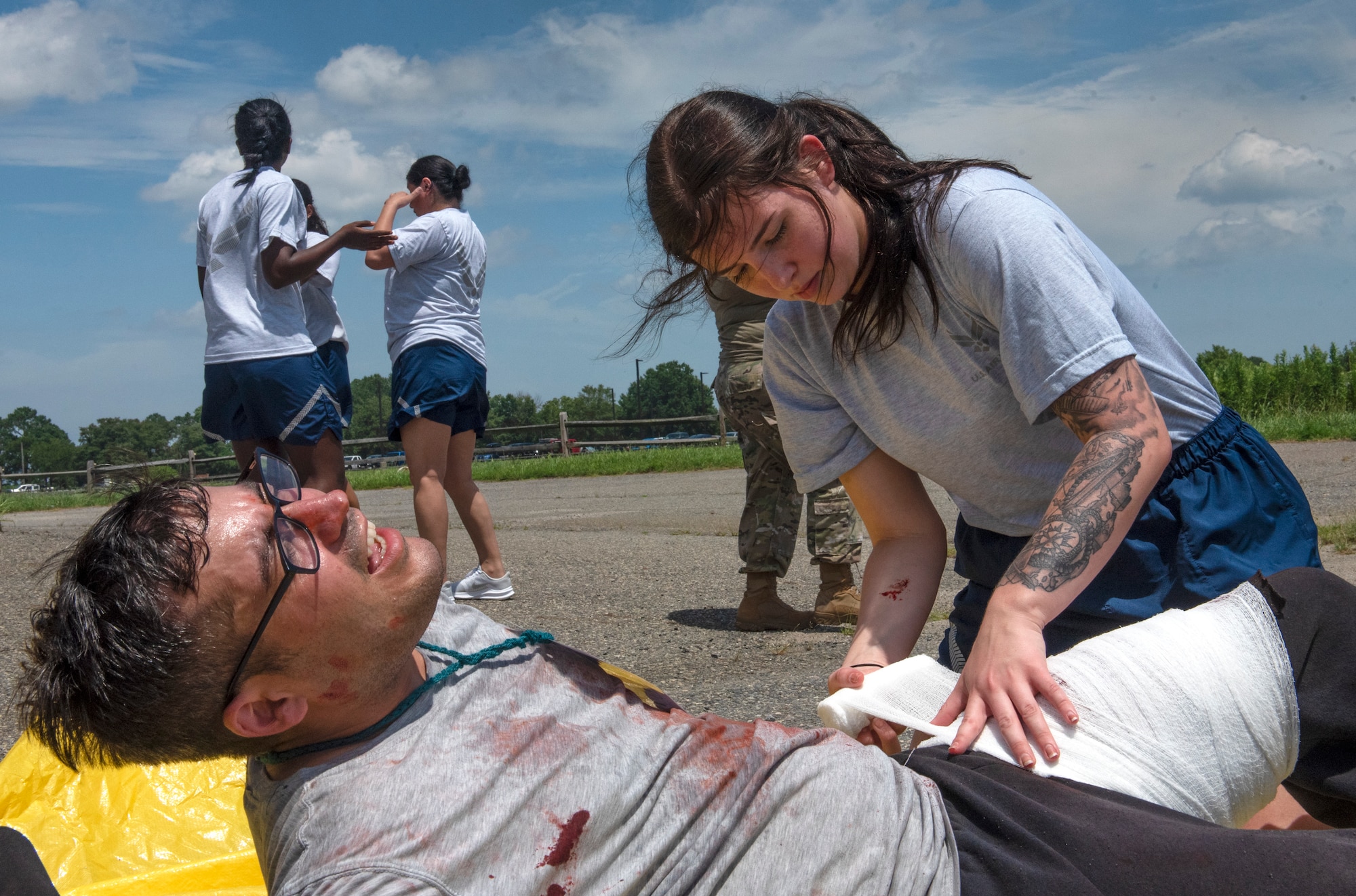 U.S. Air Force Airman 1st Class Alyssa Lemon, 633d Operational Medicine Squadron medical technician, wraps gauze around the leg of a moulage patient for the 633d Medical Group’s Comprehensive Medical Readiness Training at Joint Base Langley-Eustis, Virginia, July 28, 2022.