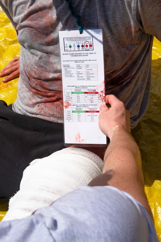 A 633d Medical Group member, reviews the health chart of a moulage patient during a 633d MDG Comprehensive Medical Readiness Training exercise at Joint Base Langley-Eustis, Virginia, July 28, 2022.