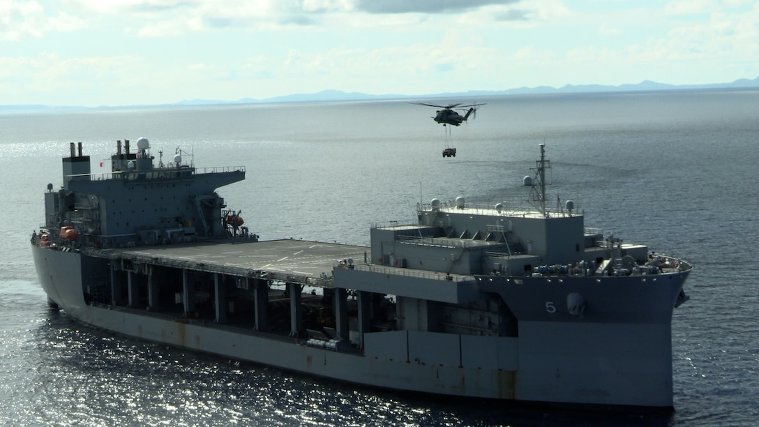 A U.S. Marine CH-53E Super Stallion, with Marine Medium Tiltrotor Squadron 262 (Rein.), 31st Marine Expeditionary Unit, carries a joint light tactical vehicle over expeditionary mobile base USS Miguel Keith (ESB-5) in the Philippine Sea, Aug. 8, 2022. This exercise proves the 31st MEU can bring heavy equipment to even the most remote locations. The 31st MEU is operating aboard ships of the Tripoli Amphibious Ready Group in the 7th Fleet area of operations to enhance interoperability with allies and partners and serve as a ready response force to defend peace and stability in the Indo-Pacific region. (U.S. Marine Corps photo by Lance Cpl. Christopher W. England)