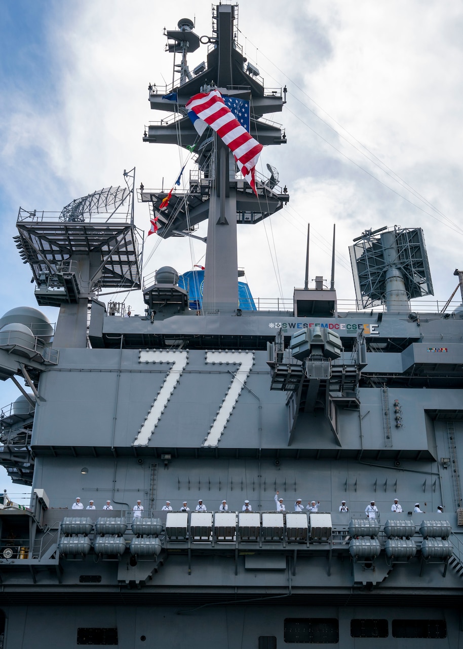 Sailors assigned to the Nimitz-class aircraft carrier USS George H.W. Bush (CVN 77) man the rails as the ship departs Naval Station Norfolk for a scheduled deployment, Aug. 10, 2022. George H.W. Bush provides the national command authority flexible, tailorable warfighting capability as the flagship of a carrier strike group that maintains maritime stability and security to ensure access, deter aggression and defend U.S., allied and partner interests.