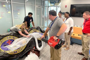 A team of missile maintainers, academia partners in Louisiana Tech University and industry partners in InnoVet, design a prototype for warming the B-52 engine during a design sprint held at the Cyber Innovation Center, Bossier City, Louisiana, July 18-21. ( Photo by Sean Green, STRIKEWERX)