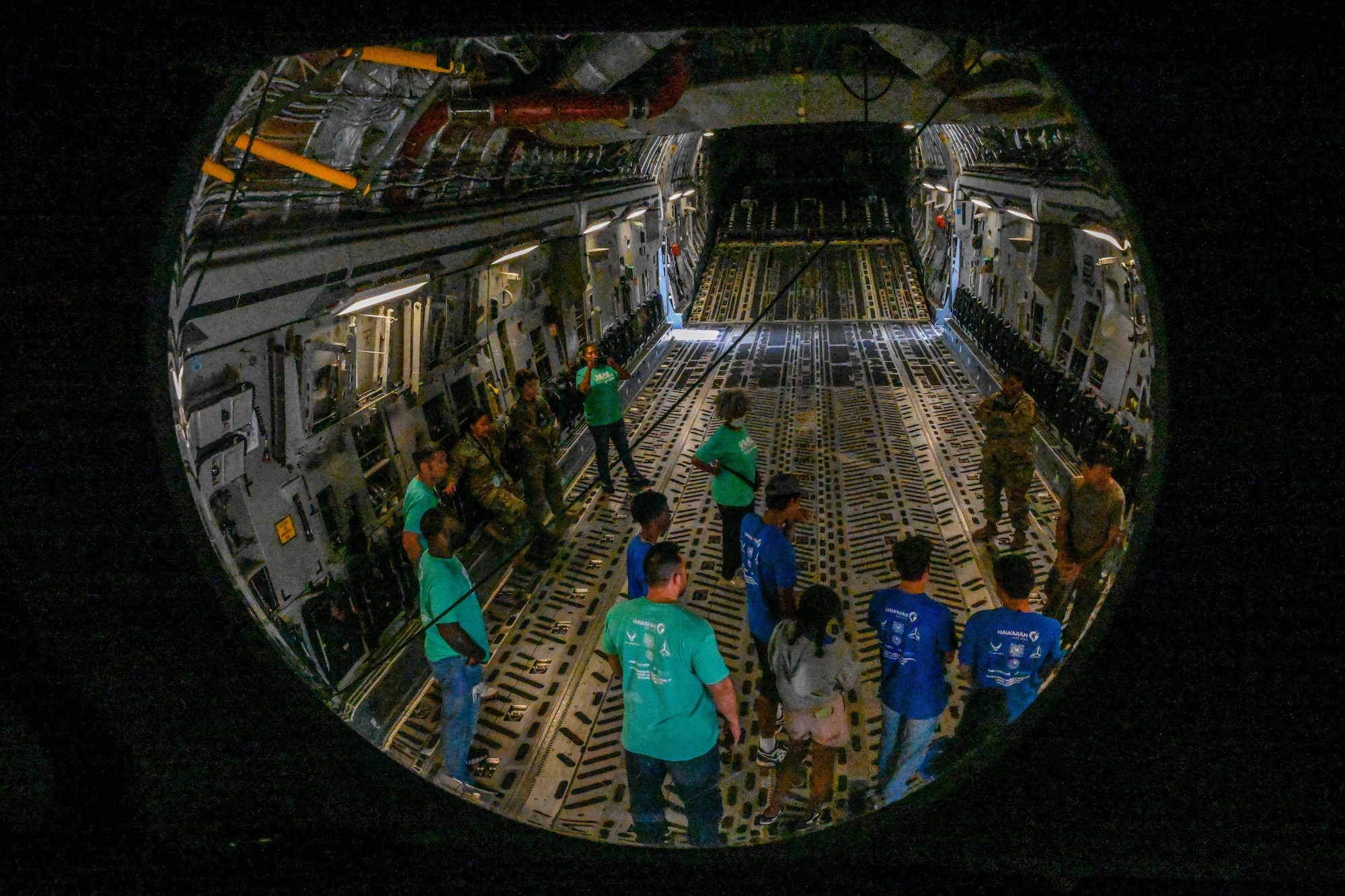 Members of the Organization of Black Aerospace Professionals tour a C-17 Globemaster III during a base tour at Joint Base Pearl Harbor-Hickam, Hawaii, July 28, 2022. The tour was a part of the Aerospace Career Education Academy, introducing children between the ages of 13-18 to opportunities that exist in the aviation industry. (U.S. Air Force photo by Senior Airman Makensie Cooper)