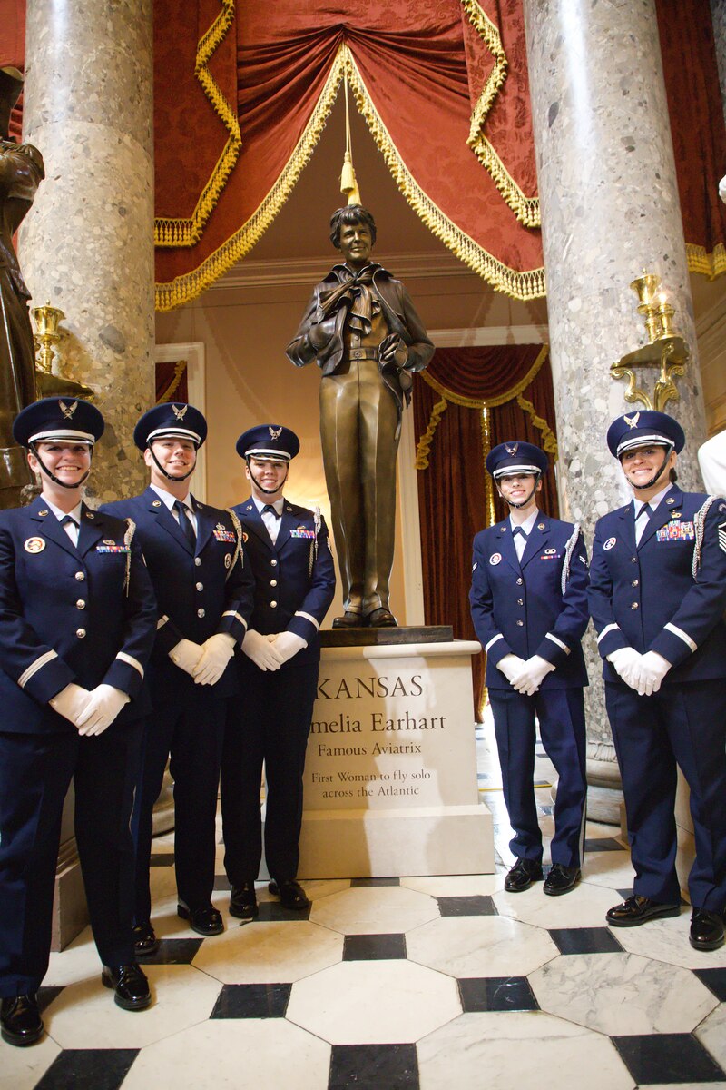 Honor Guard posing with statue of Amelia Earhart