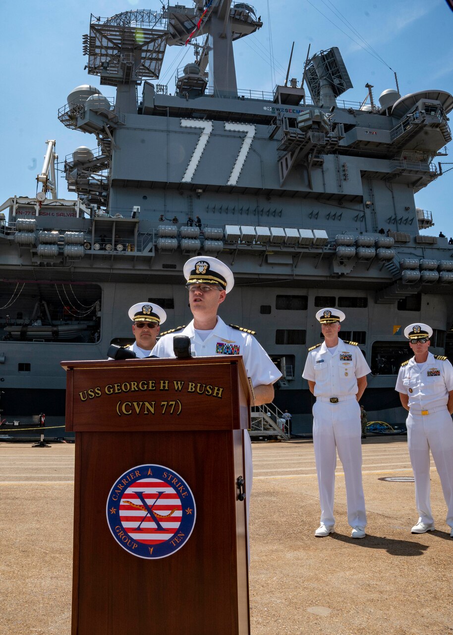 Capt. Dave Pollard, commanding officer of the Nimitz-class aircraft carrier USS George H.W. Bush (CVN 77), delivers remark during a press conference as the ship prepares to depart Naval Station Norfolk for a scheduled deployment Aug. 10, 2022. George H.W. Bush provides the national command authority flexible, tailorable warfighting capability as the flagship of a carrier strike group that maintains maritime stability and security to ensure access, deter aggression and defend U.S., allied and partner interests.