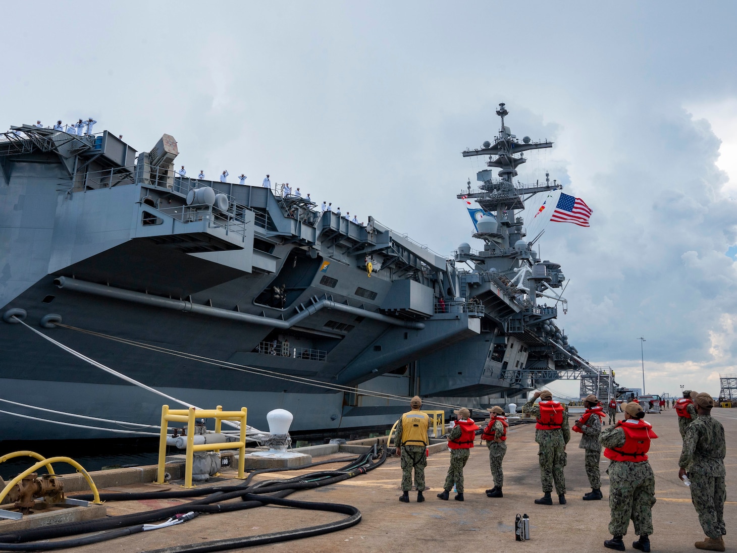 Sailors assigned to the Nimitz-class aircraft carrier USS George H.W. Bush (CVN 77) man the rails as the ship departs Naval Station Norfolk for a scheduled deployment, Aug. 10, 2022. George H.W. Bush provides the national command authority flexible, tailorable warfighting capability as the flagship of a carrier strike group that maintains maritime stability and security to ensure access, deter aggression and defend U.S., allied and partner interests.