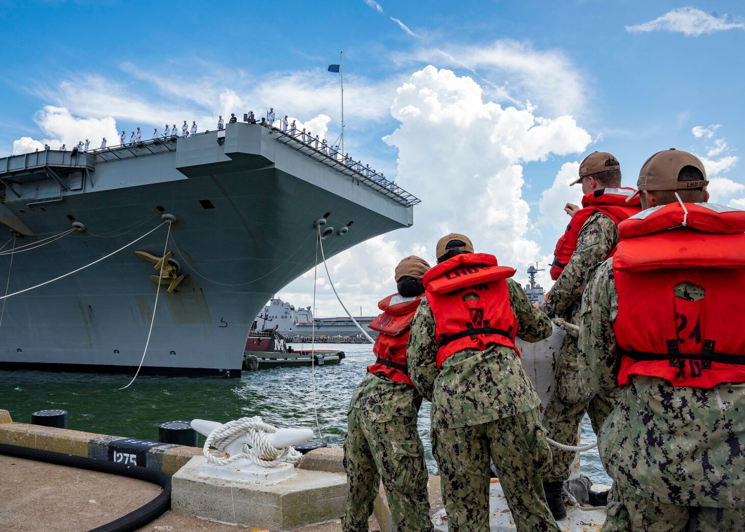 Sailors assigned to the Nimitz-class aircraft carrier USS George H.W. Bush (CVN 77) man the rails as the ship departs Naval Station Norfolk for a scheduled deployment, Aug. 10, 2022. George H.W. Bush provides the national command authority flexible, tailorable warfighting capability as the flagship of a carrier strike group that maintains maritime stability and security to ensure access, deter aggression and defend U.S., allied and partner interests.