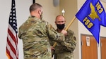 Lt. Col. Joseph Crispen (right), accepts the 183d Force Support Squadron (FSS) guidon from Col. Shawn Green, Commander, 183d Mission Support Group (left), as he accepts command of FSS. (U.S. Air National Guard photo by Master Sgt. Patrick Kerr)