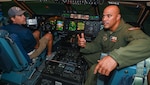 Lt. Col. Christopher Jones, 68th Airlift Squadron C-5M pilot, guides Brad Tobler, Wish for Our Heroes chapter director and co-owner of Federal Employee Benefits, inside the C-5M Super Galaxy flight simulator at Joint Base San Antonio-Lackland, Texas, Aug. 6, 2022. The flight simulator was part of an honorary commander tour of the 433rd Operations Group. (U.S. Air Force photo by Airman 1st Class Mark Colmenares)