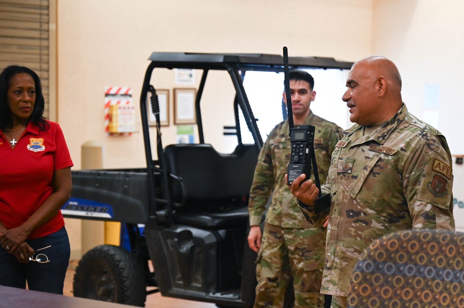 Master Sgt. Richard Garcia, 433rd Operations Support Squadron aircrew flight equipment lead trainer, holds a radio while instructing a group of honorary commanders about survival tools and skills at Joint Base San Antonio-Lackland, Texas, Aug. 6, 2022. The honorary commanders' program helps bridge the gap between the military and community. (U.S. Air Force photo by Senior Airman Brittany Wich)