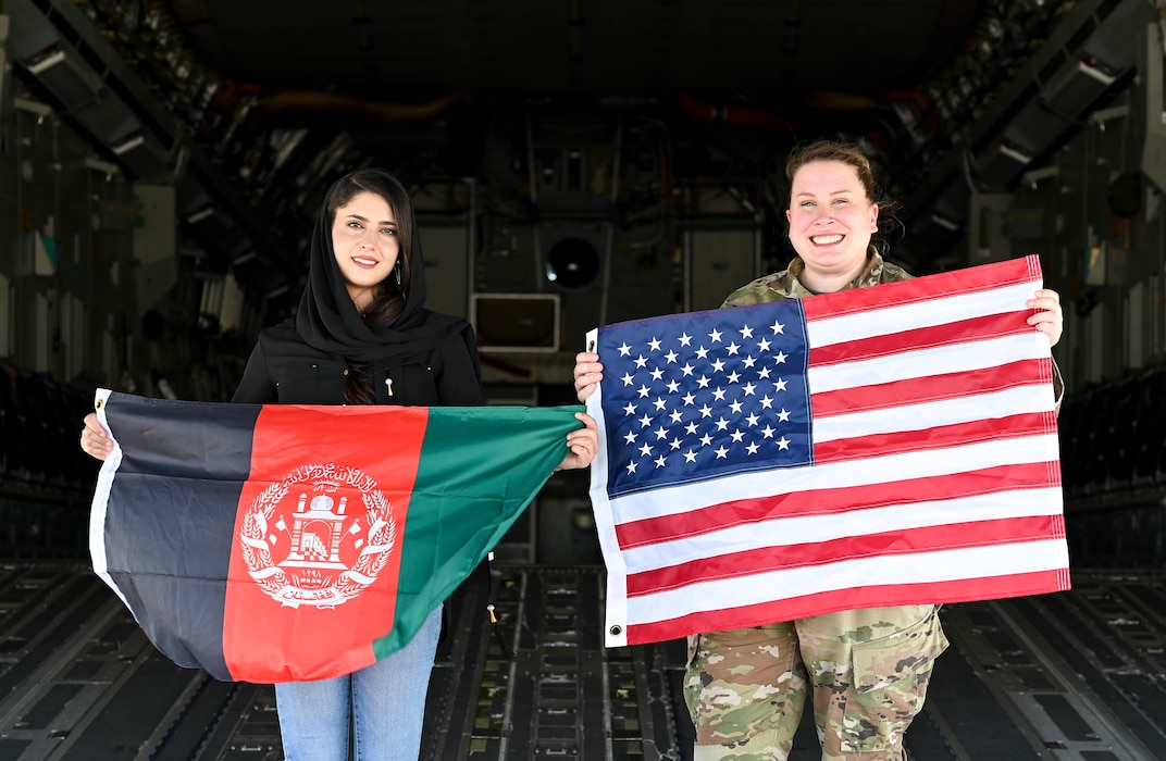Tech. Sgt. Ashley Majewski, right, 436th Operational Medical Readiness Squadron dental facility manager and logistics noncommissioned officer in charge, and Zarafshan “Zaro” Mirzaie, an Afghan evacuee, revisit the same C-17 Globemaster III that carried Zaro to the U.S., reflecting on the one year anniversary of Operation Allies Refuge at Dover Air Force Base, Delaware, Aug. 8, 2022. After flying out of Afghanistan during OAR, Zaro met and began working with Majewski at a hair salon during Operation Allies Welcome on Joint Base McGuire-Dix-Lakehurst, New Jersey. (U.S. Air Force photo by Senior Airman Stephani Barge)