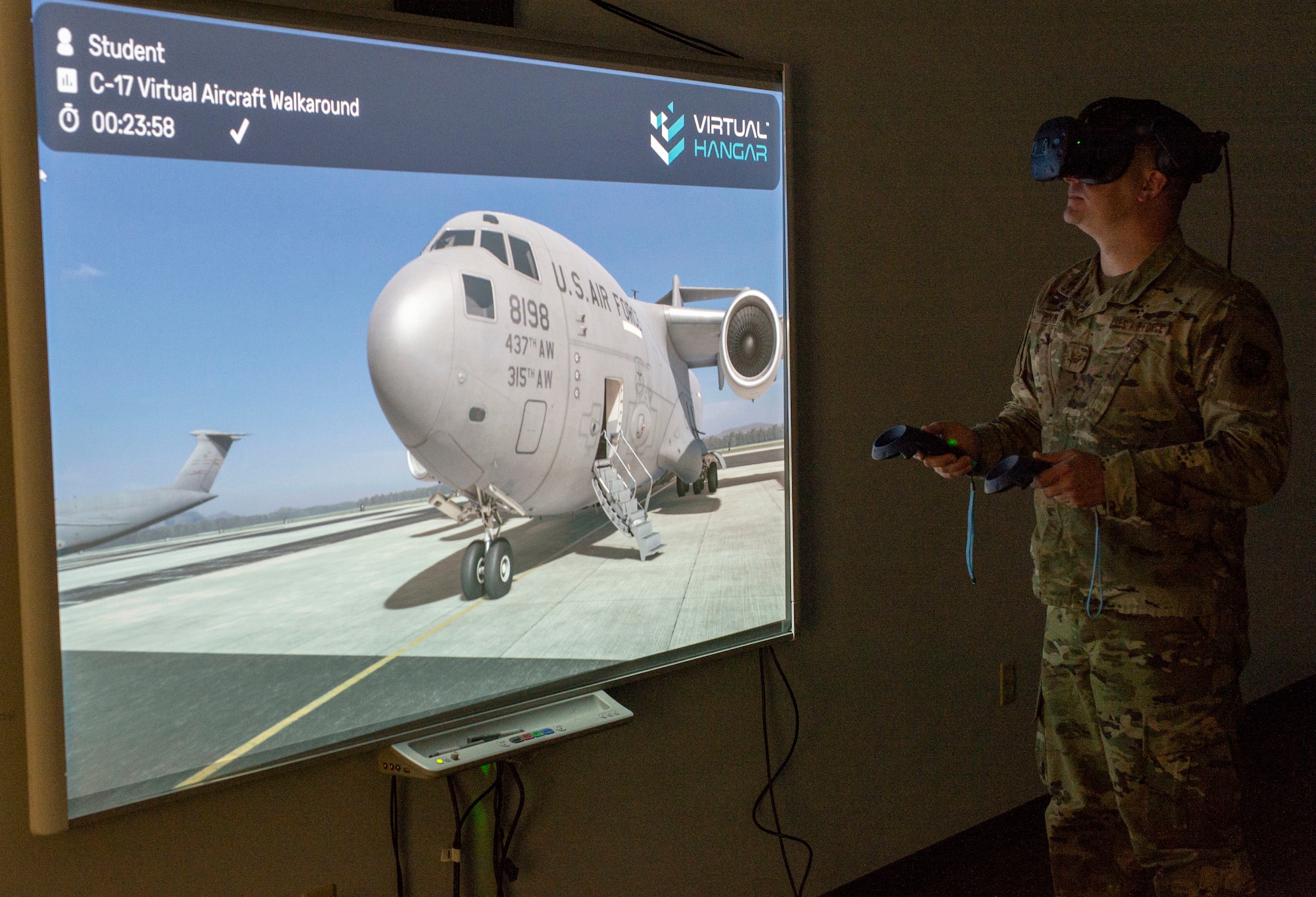 Staff Sgt. James Hart, 436th Aerial Port Squadron fleet services supervisor, walks around a C-17 Globemaster III using virtual reality goggles during a multi-capable Airmen training class at Dover Air Force Base, Delaware, March 29, 2022. Hart and other MCA students used VR goggles to familiarize themselves with C-17 and C-5M Super Galaxy aircraft by performing a virtual walkaround. (U.S. Air Force photo by Roland Balik)