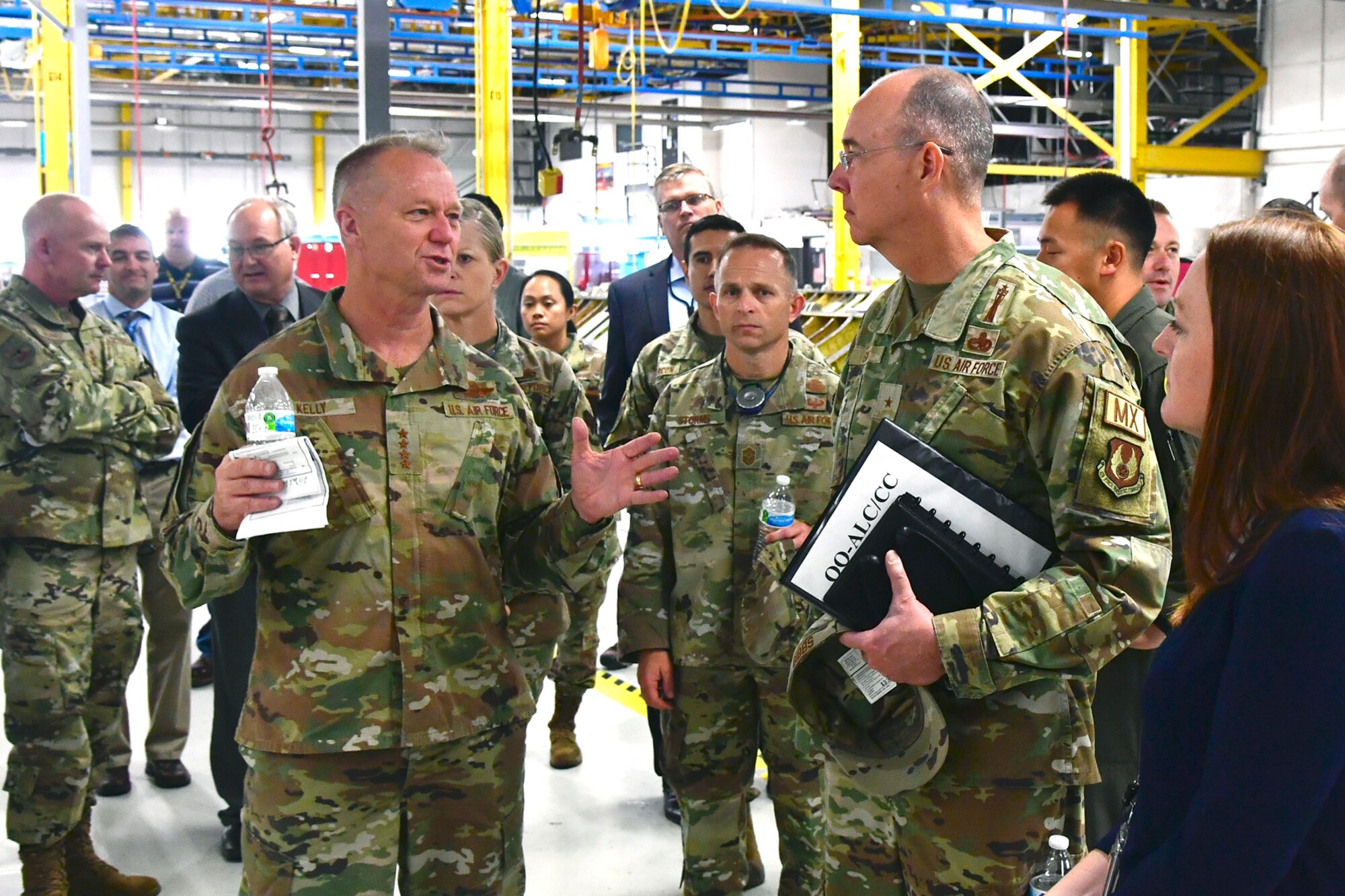 Gen. Mark D. Kelly (left), Air Combat Command commander, speaks with Brig. Gen. Richard W. Gibbs, Ogden Air Logistics Complex commander.