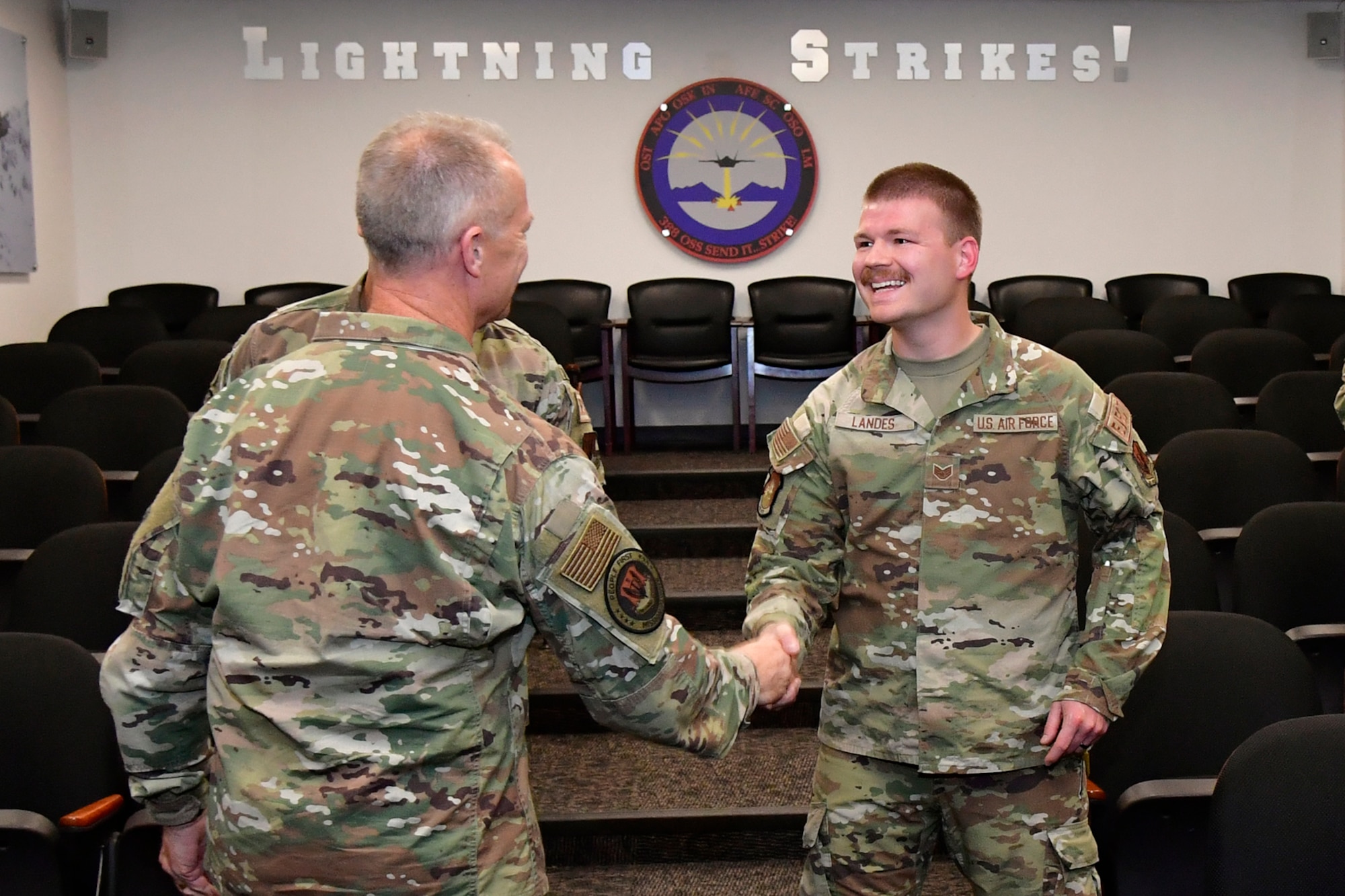 Staff Sgt. Luke Landes (right), 388th Maintenance Squadron, shakes hands with Gen. Mark D. Kelly, Air Combat Command commander.