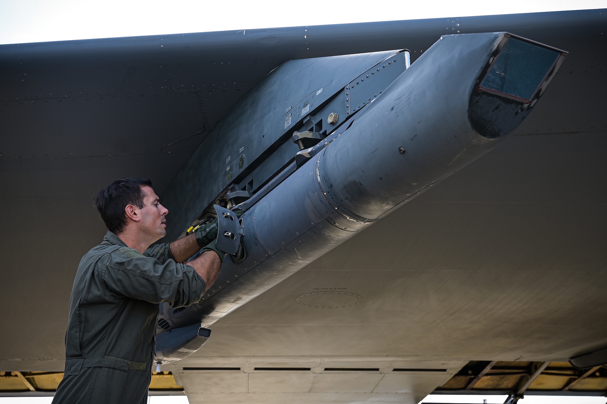 Capt. Jonathan Acker, 20th Bomb Squadron navigator, inspects the sniper pod on a B-52H Stratofortress in support of RIMPAC 2022 at Barksdale Air Force Base, Aug. 1, 2022. Twenty-six nations, 38 ships, three submarines, more than 170 aircraft and 25,000 personnel are participating in RIMPAC from June 29 to Aug. 4 in and around the Hawaiian Islands and Southern California. The world’s largest international maritime exercise, RIMPAC provides a unique training opportunity while fostering and sustaining cooperative relationships among participants critical to ensuring the safety of sea lanes and security on the world’s oceans. RIMPAC 2022 is the 28th exercise in the series that began in 1971. (U.S. Air Force photo by Senior Airman Jonathan E. Ramos)