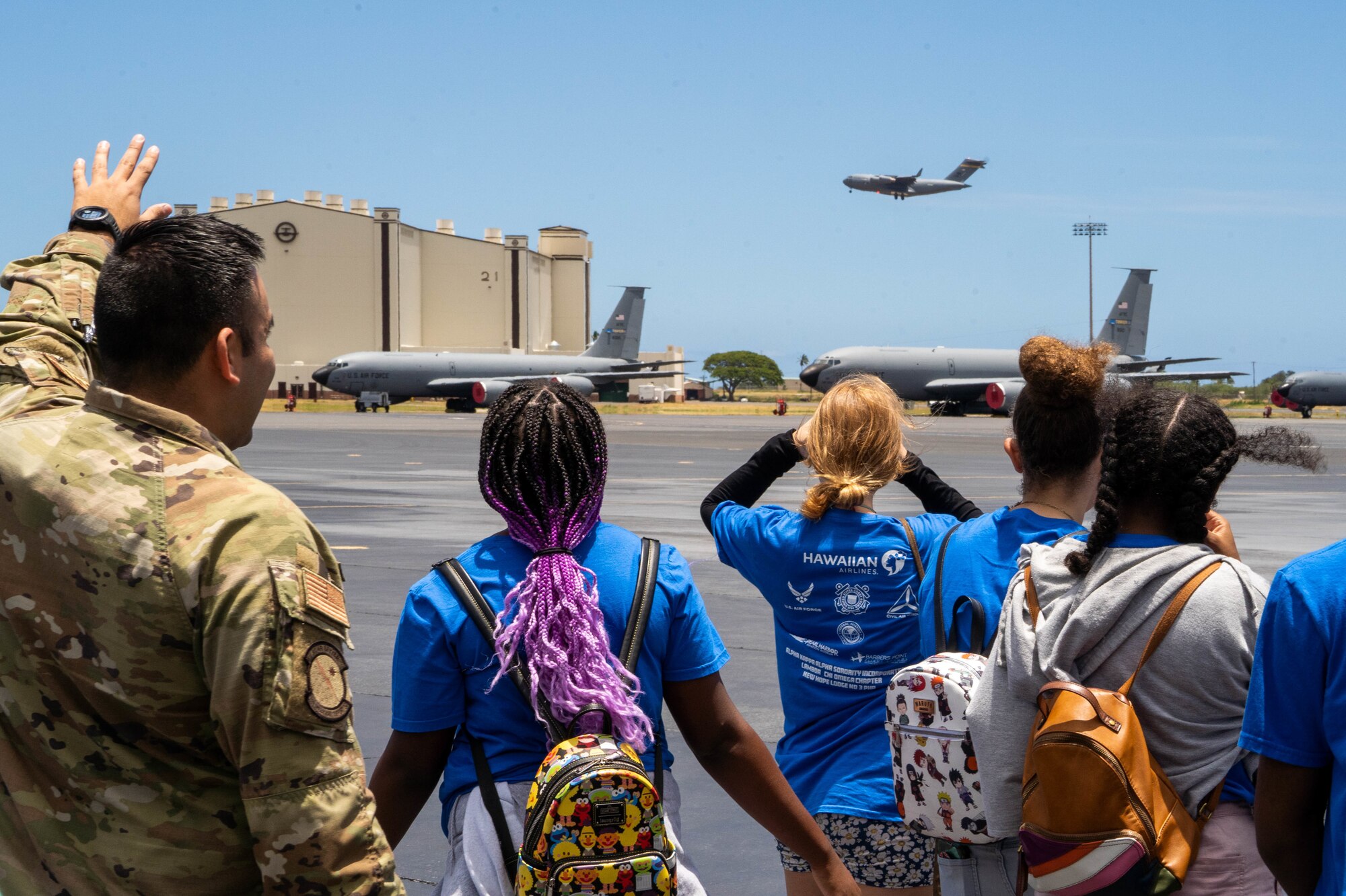 Staff Sgt. Benjamin Soto Garcia, 15th Operations Support Squadron airfield management operations supervisor, identifies a C-17 Globemaster III to members of the Organization of Black Aerospace Professionals as it lands at Hickam Airfield at Joint Base Pearl Harbor-Hickam, Hawaii, July 28, 2022. The goal of OBAP is to educate children between the ages of 13-18 to opportunities that exist in the aviation industry. (U.S. Air Force photo by Senior Airman Makensie Cooper)