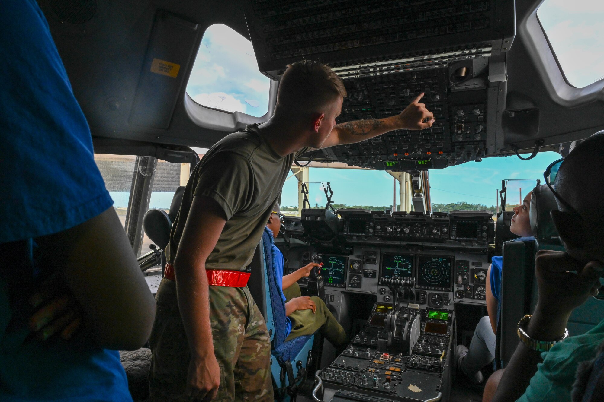 An Airman assigned to 15th Aircraft Maintenance Squadron speaks with visitors from the Organization of Black Aerospace Professionals during a base tour at Joint Base Pearl Harbor-Hickam, Hawaii, July 28, 2022. The tour was a part of the Aerospace Career Education Academy, a collaboration with the Federal Aviation Administration and OBAP. (U.S. Air Force photo by Senior Airman Makensie Cooper)