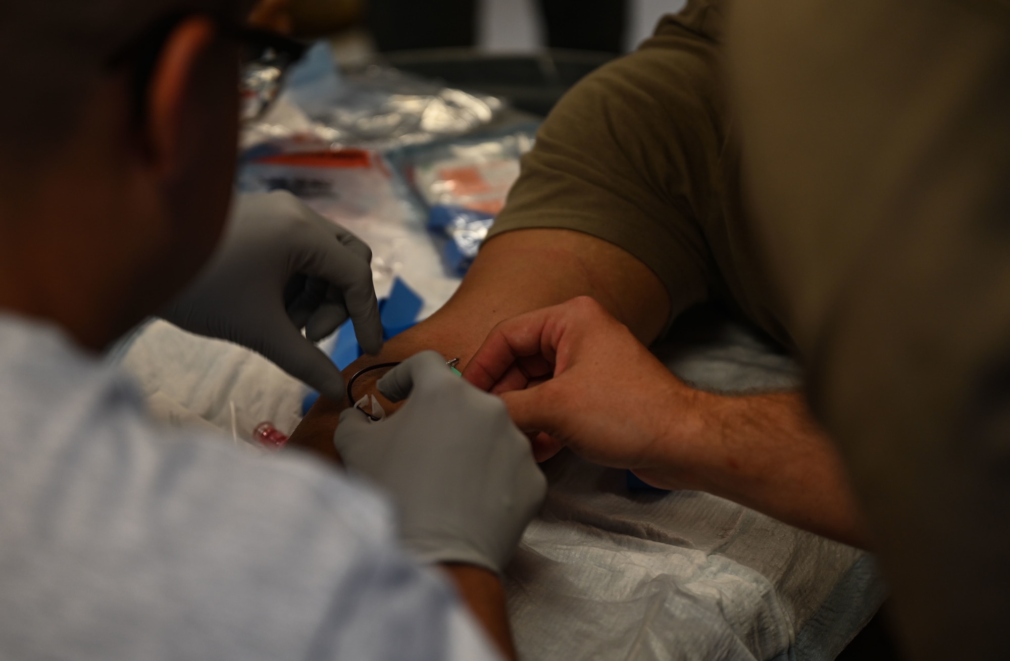 U.S. Airmen from the 633d Medical Group perform intravenous access during the Comprehensive Medical Readiness Training exercise at Joint Base Langley-Eustis, Virginia, July 28, 2022.