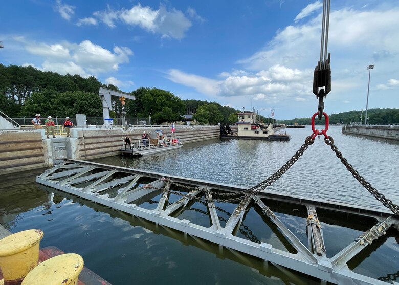 Nashville District divers Joshua McGlinch and Matthew Chambers prepare for the next part of the maintenance routine. McGlinch gets ready to reenter the water and unhook the stop log from the crane at Cheatham Lock in Ashland City, TN.