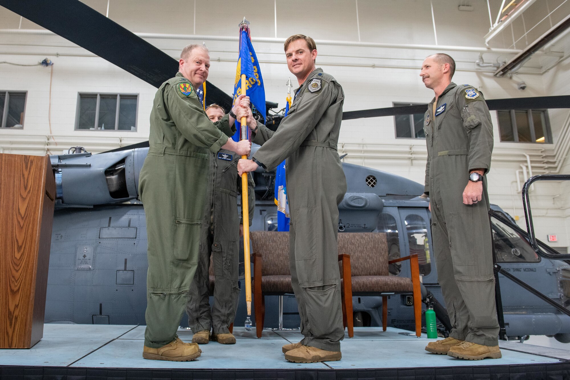 Colonel Jesse L. Hamilton, 943d Rescue Group commander, presents the guidon to Lt. Col. Brough L. McDonald as he assumes command of the 305th Rescue Squadron during a ceremony Aug. 5, 2022 at Davis-Monthan Air Force Base, Ariz. (U.S. Air Force photo by Senior Airman Nicole Koreen)