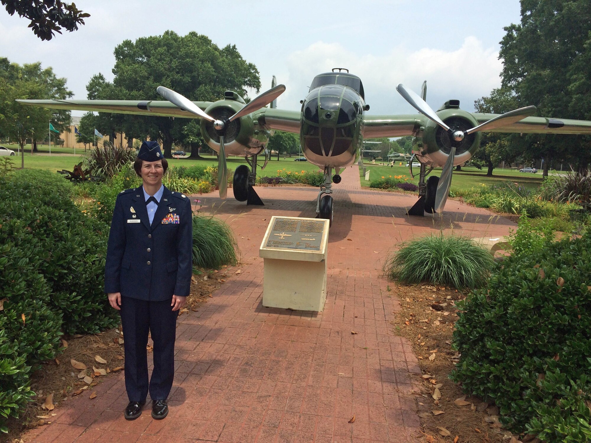 Then Lt Col McNamara stands in front of a B-25 bomber display at Maxwell AFB, Ala.