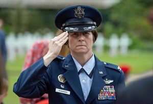 Col. Bridget McNamara, 422nd Air Base Group commander, salutes while at the Brookwood American Cemetery in the United Kingdom during Memorial Day event in 2019.