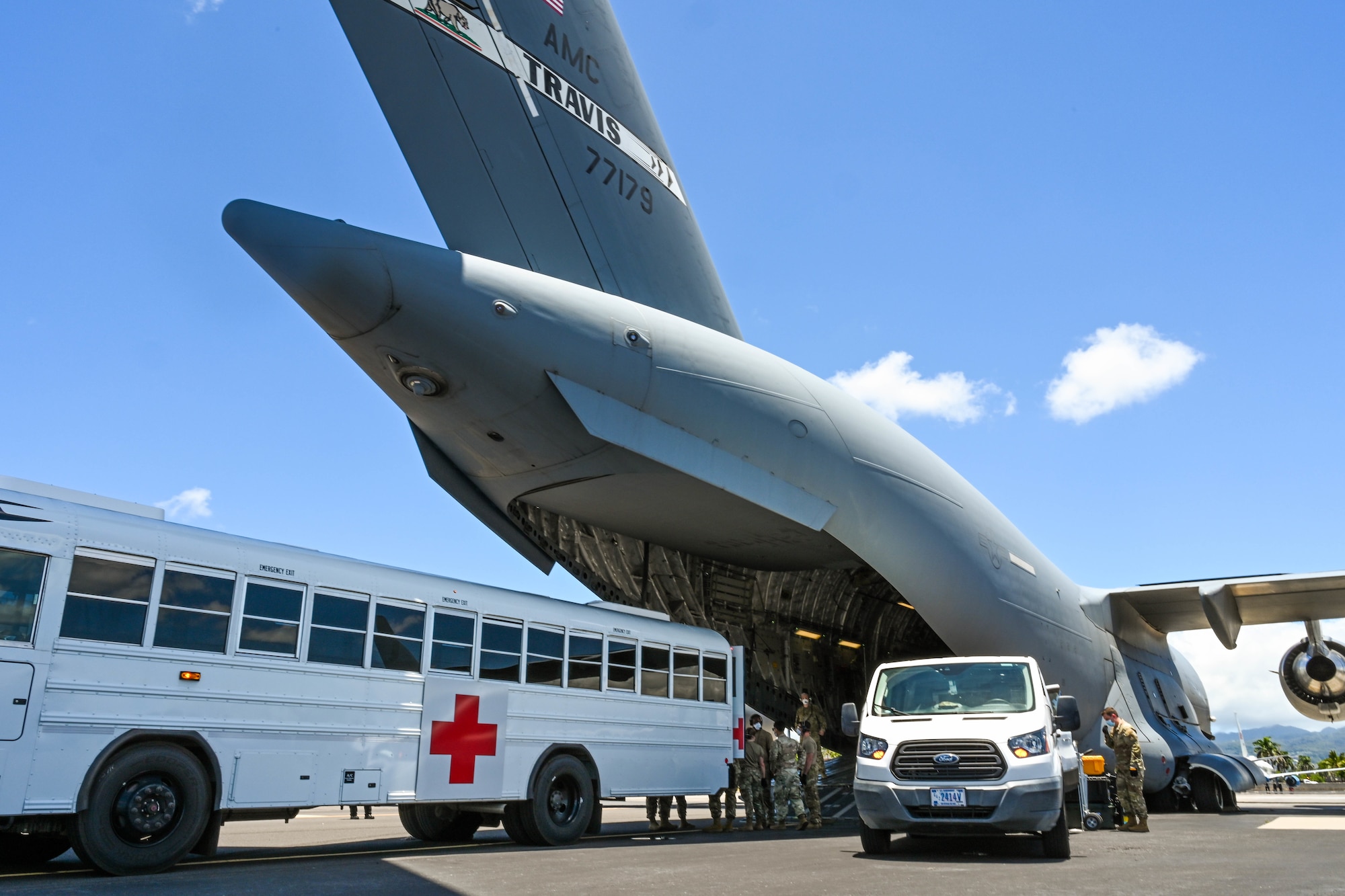 Hickam Airmen work alongside Airmen from Travis Air Force Base, California, and Joint Base San Antonio, Texas, during an aeromedical evacuation at Joint Base Pearl Harbor-Hickam, July 27, 2022. Airmen from all three installations came together to provide time sensitive, mission critical en route care to patients during a flight. (U.S. Air Force photo by Senior Airman Makensie Cooper)