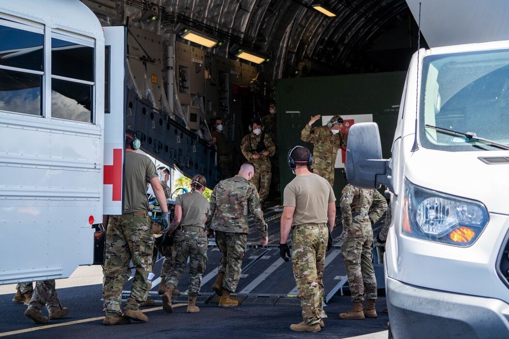 Hickam Airmen work alongside
Airmen from Travis Air Force Base,
California, and Joint Base San
Antonio, Texas, to transport a patient
onto a C-17 Globemaster III during
an Aeromedical Evacuation Mission at
Joint Base Pearl Harbor-Hickam, July
27, 2022. Airmen are prepared to
administer life-saving medical care to
patients while in the air flying to a
medical center. (U.S. Air Force photo by Senior Airman Makensie Cooper)