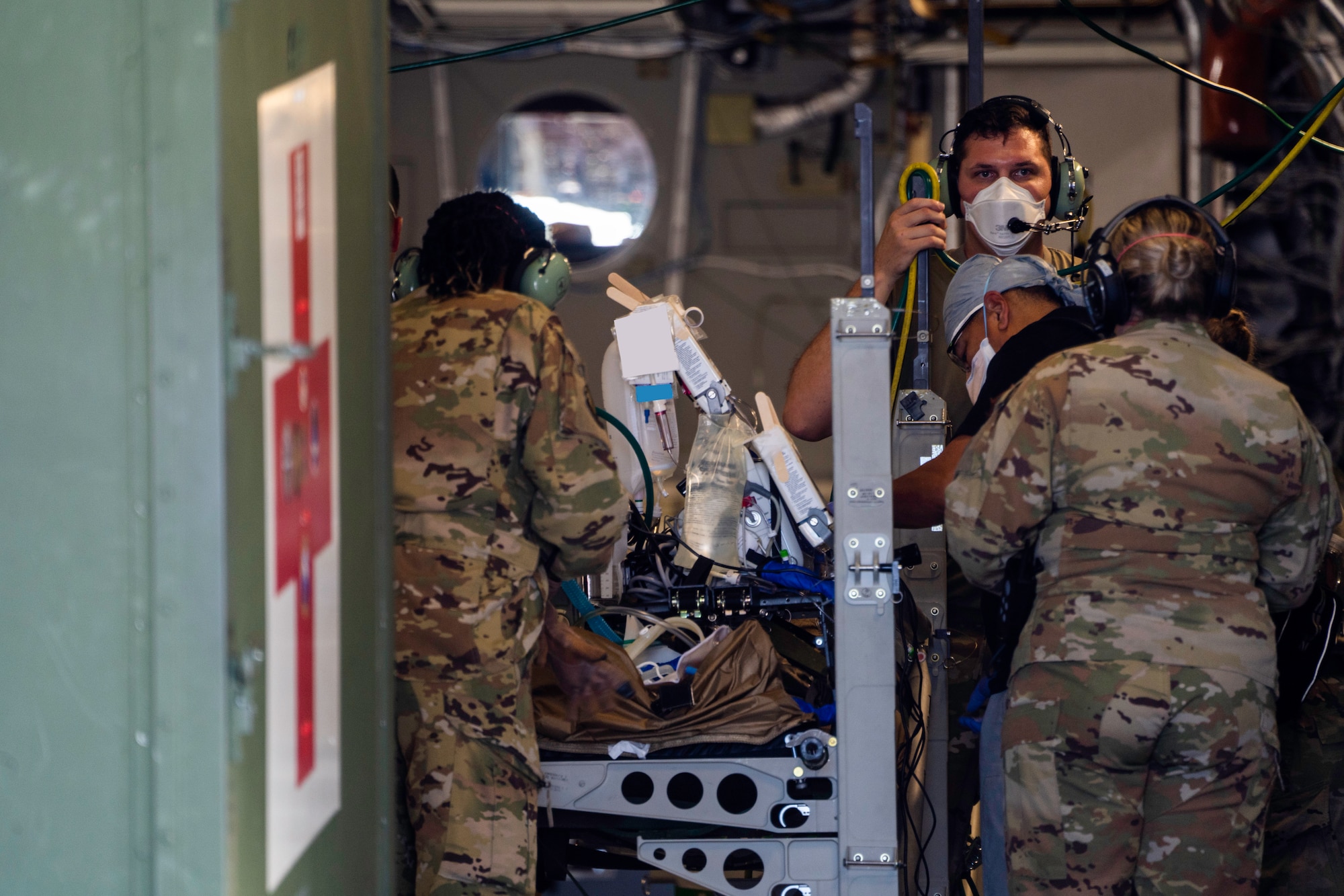 Hickam Airmen work alongside Airmen
from Travis Air Force Base, California,
and Joint Base San Antonio, Texas,
during an aeromedical evacuation at
Joint Base Pearl Harbor-Hickam, July 27,
2022. Airmen from all three installations
came together to provide time sensitive,
critical en route care to patients
during a flight. (U.S.
Air Force photo by Senior Airman
Makensie Cooper) (Image altered for PII
purposes)