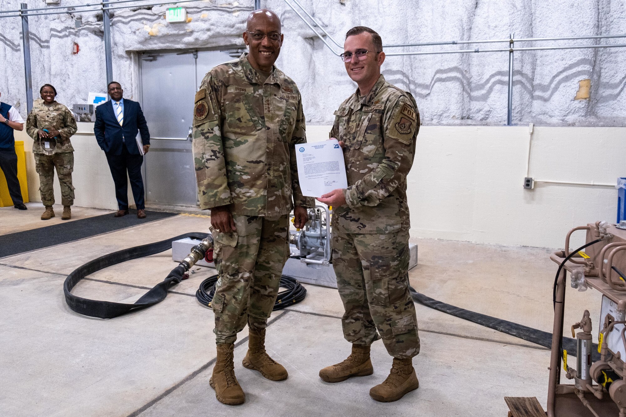CSAF poses for a photo with an Airman.