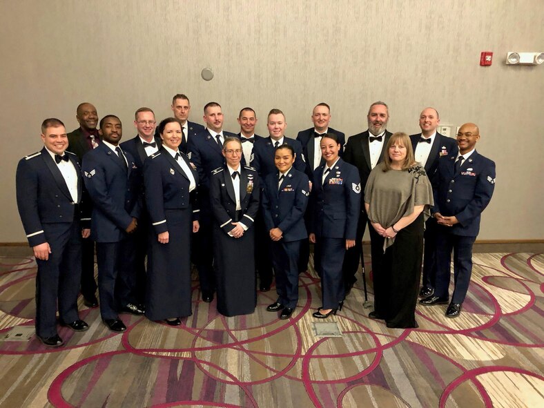 Lt Col. Allison Minnig stand with her team, the 595th Strategic Communications Sqaudron