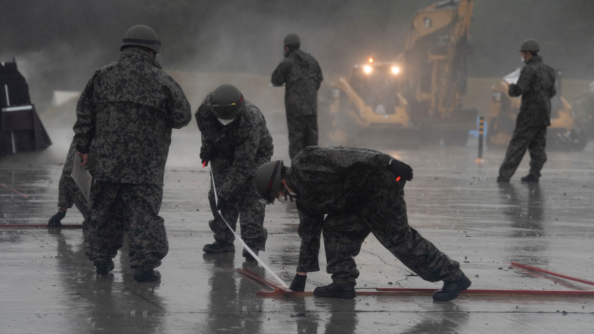 Personel work outside in the rain