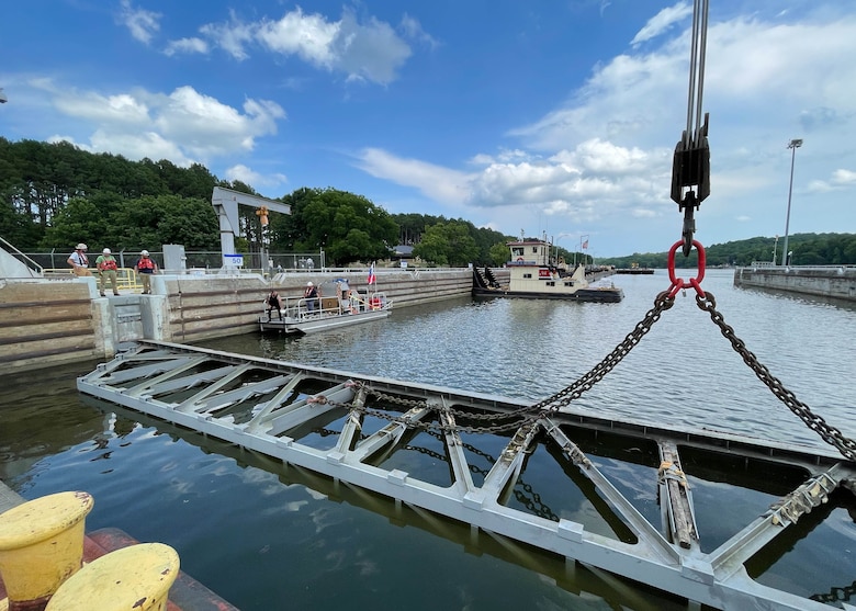 Nashville District divers Joshua McGlinch and Matthew Chambers prepare for the next part of the maintenance routine. McGlinch gets ready to reenter the water and unhook the stop log from the crane at Cheatham Lock in Ashland City, TN.