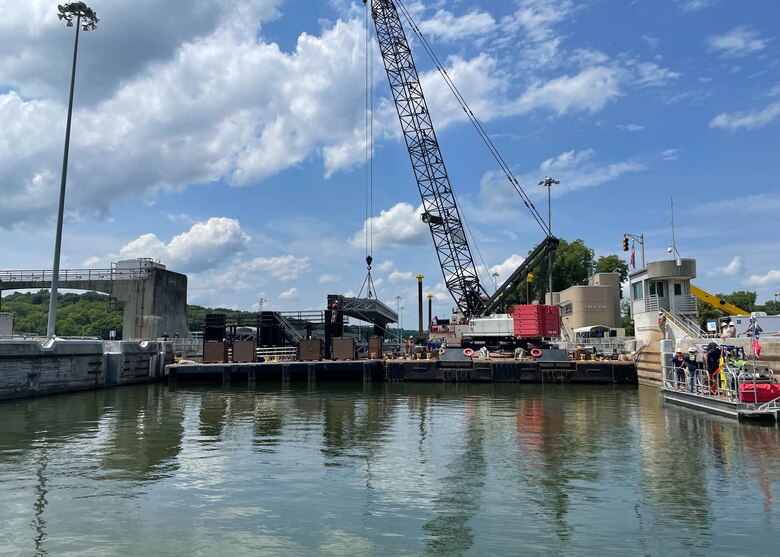 Nashville District and Huntington District engineers prepare one of four 63,000-pound stop logs for installation at Cheatham Lock in Ashland City, TN. Nashville District Divers wait underwater for the log placement, which a support team communicates with the divers by radio.