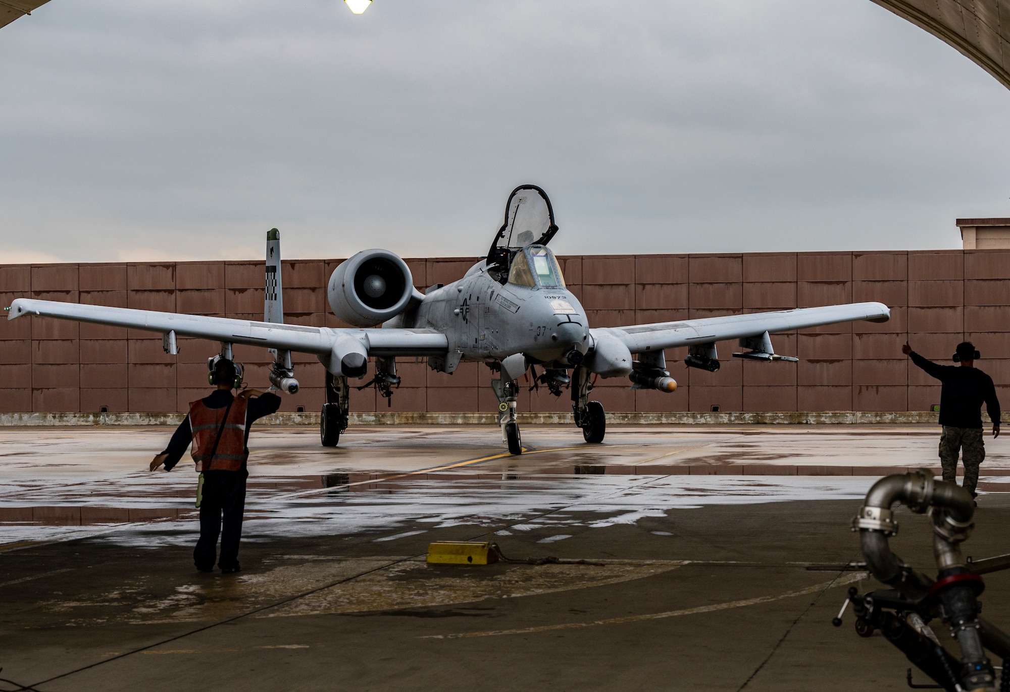 Airmen assigned to the 25th Fighter Generation Squadron signal an A-10C Thunderbolt II on the flightline