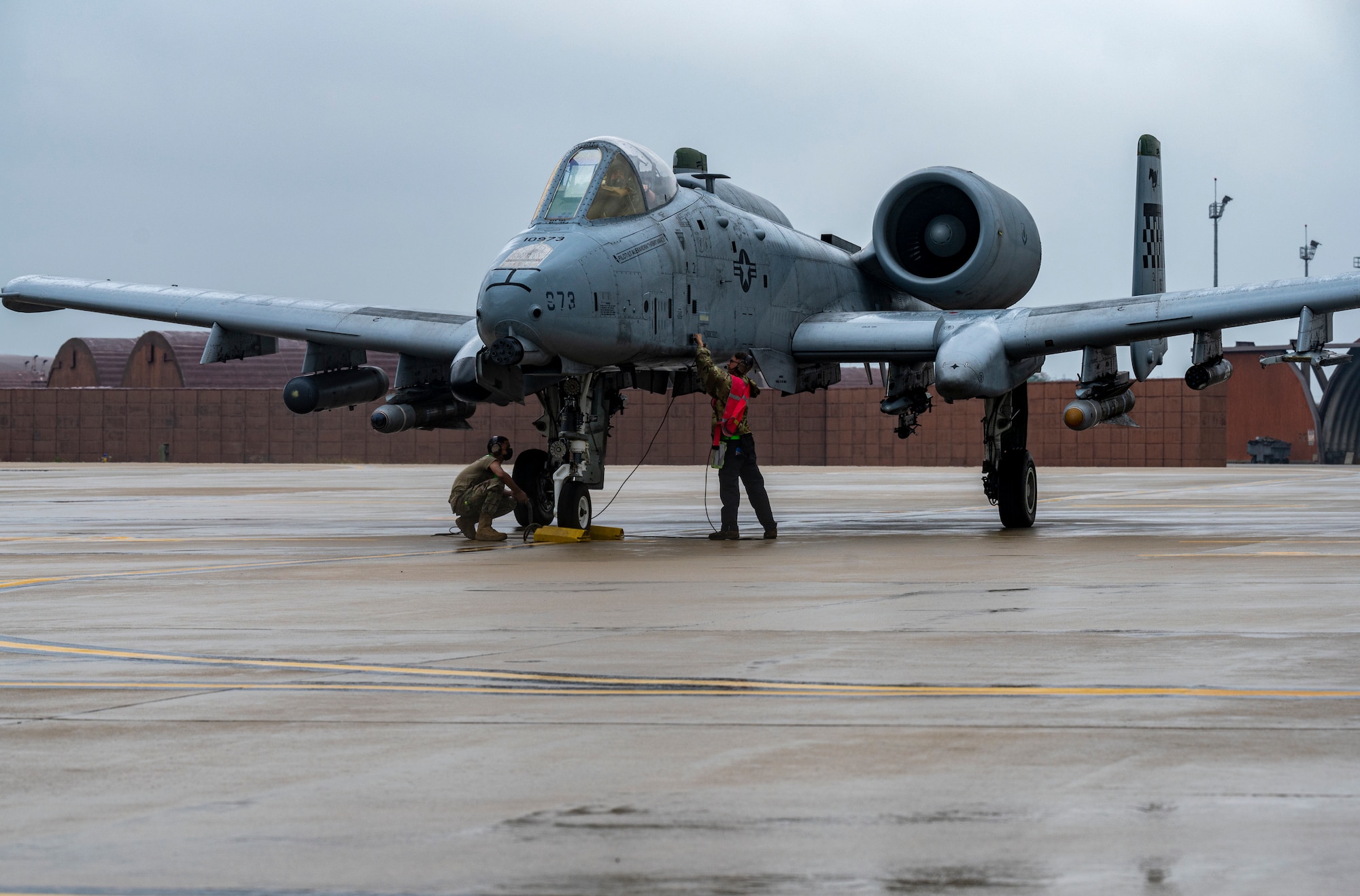 Airmen assigned to the 25th Fighter Generation Squadron perform preflight checks on an A-10C Thunderbolt II