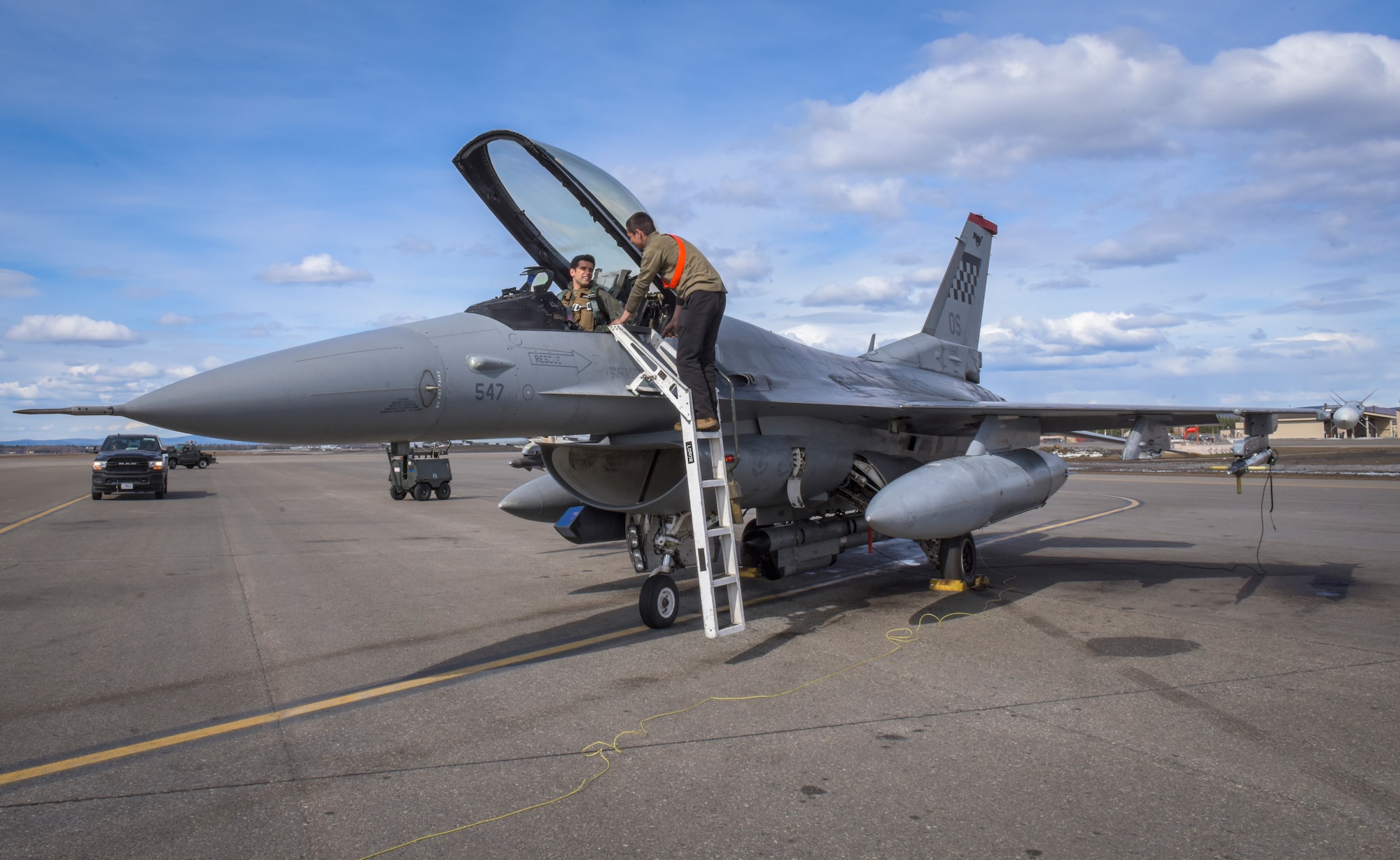 Capt. Connor Watson, 36th Fighter Squadron, pilot, laughs with Senior Airman Manuel Hernandez, 36th Fighter Generation Squadron, crew chief, before his flight in support of RED FLAG-Alaska 22-1