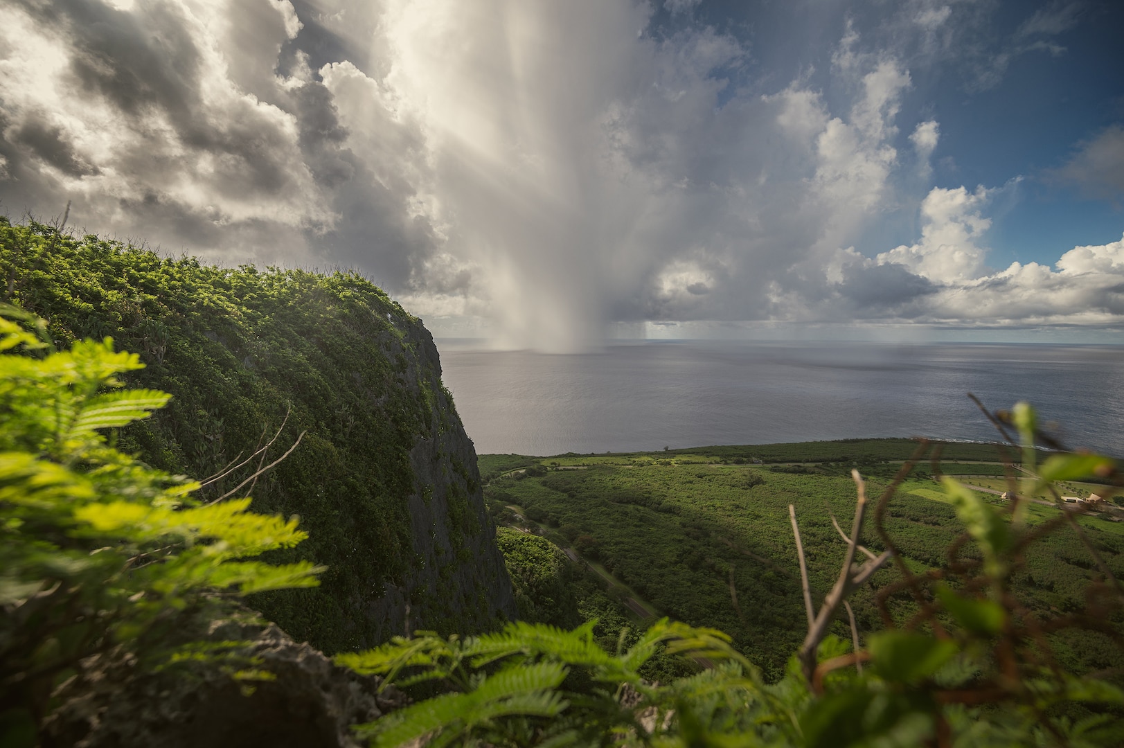 A view from the top of the Suicide Cliffs on Saipan as a rain cloud moves in. A group of airmen assigned to the 157th Air Refueling Wing flew to Saipan aboard a KC-46 Pegasus as part of a super sortie endurance exercise, Aug. 5, 2022.