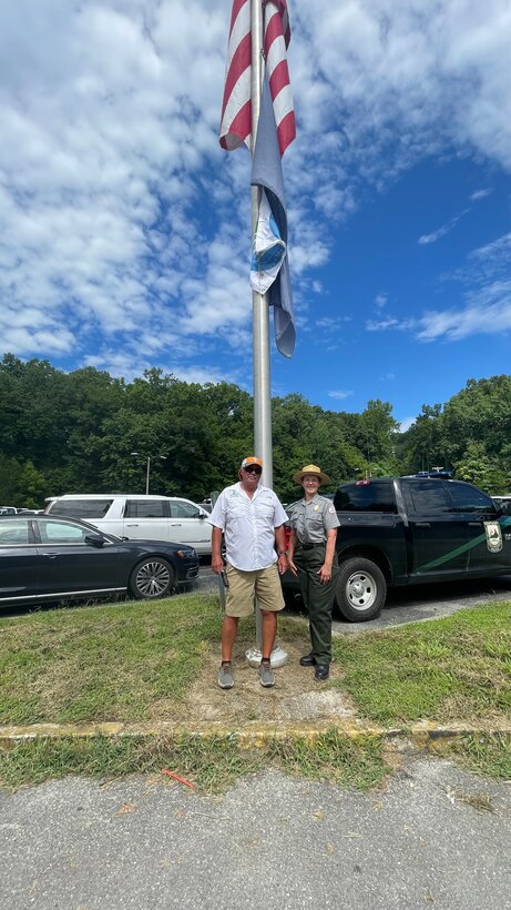 Dale Hollow State Park Marina General Manager Glen Stone and Clean Marina Coordinator and Dale Hollow Park Ranger Sondra Carmen hoist the Clean Marina Award flag at the Dale Hollow State Park Marina front parking lot on Aug. 6, 2022.