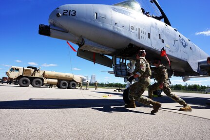 U. S. Air Force Airmen from the 127th Aircraft Maintenance Squadron, Selfridge Air National Guard Base, (SANGB) Mich. perform Agile Combat Employment (ACE) training while loading bombs onto an A-10 Thunderbolt II also from SANGB during an Integrated Combat Turn (ICT) during Northern Agility 22-2/Northern Strike 22, at Cherry Capital Airport in Traverse City, Mich., Aug. 8, 2022.