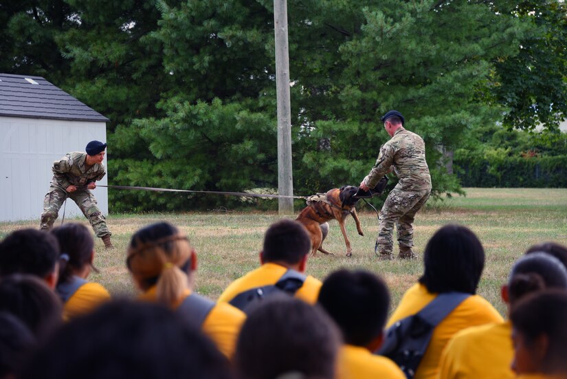 Airmen presents K-9 training demonstration to the Youth Academy class.