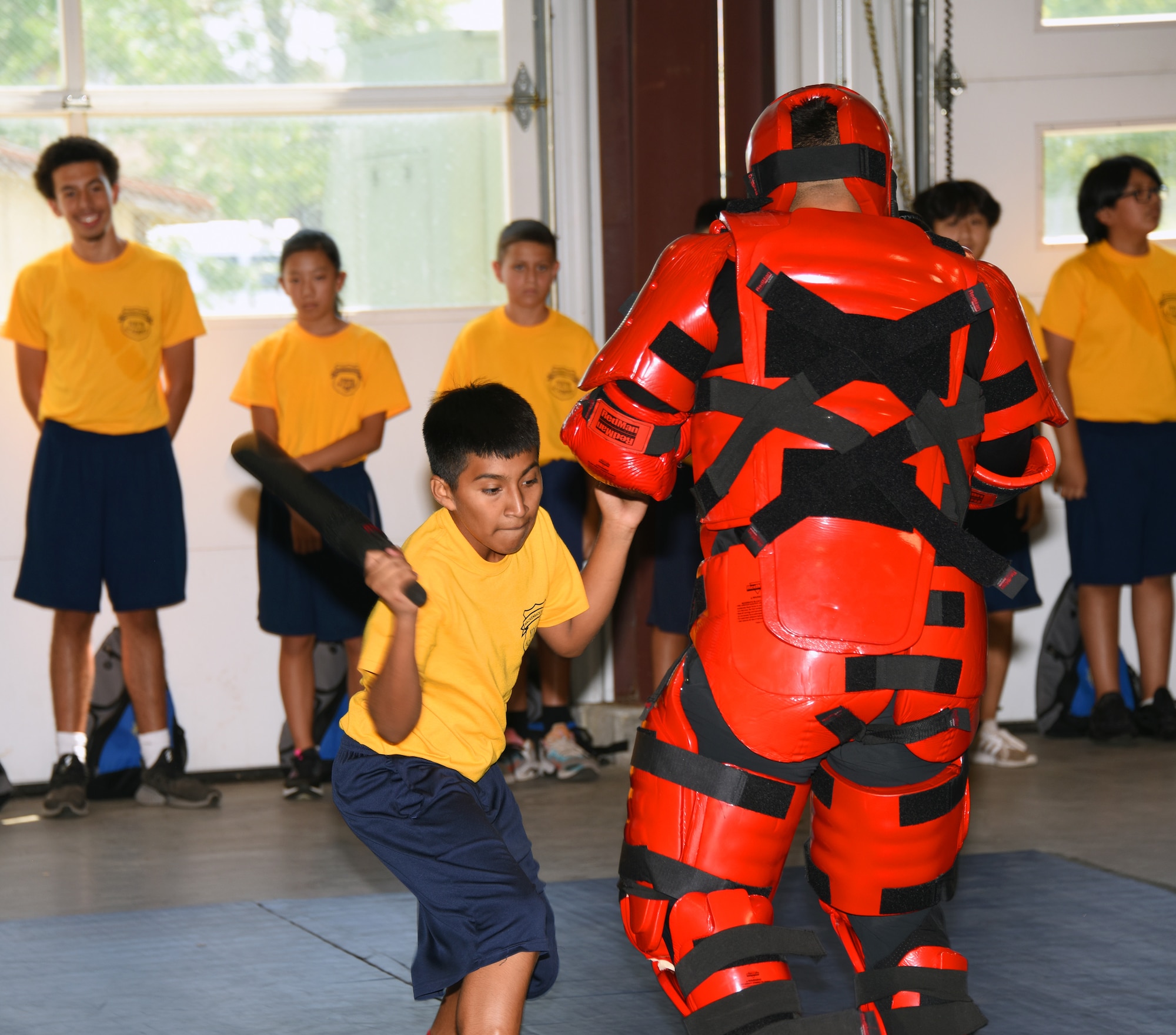 A Youth Academy class participant performing a physical exercise with an instructor.